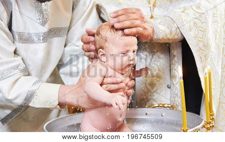 The sacrament of baptism. Newborn baby during christening