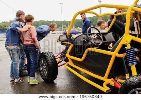 Orel Russia July 22 2017: Dynamica car festival. People look at buggy car with interest at rainy day