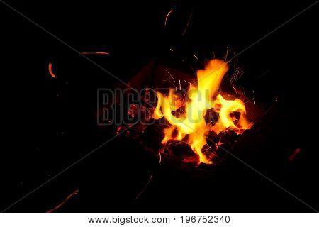 Hot sparking live-coals burning in a barbecue
