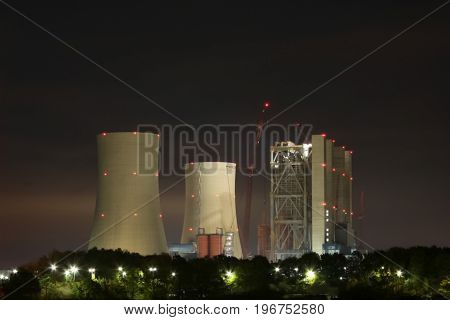 The large power plant produces a lot of smoke