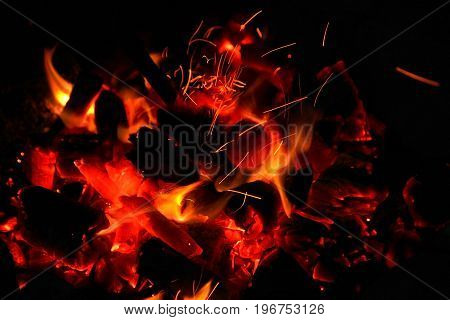 Hot sparking live-coals burning in a barbecue