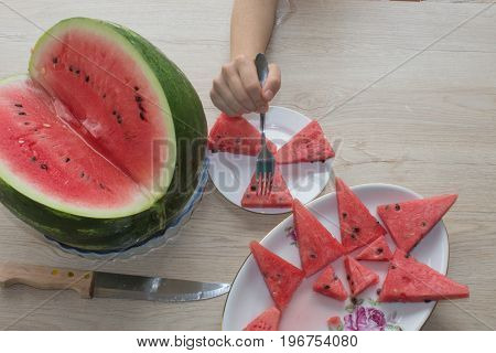 Slices of juicy and tasty watermelon on a white plate. Triangle shaped watermelon slices