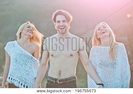 Love and romance. Girl and women with boyfriend outdoor. Blonde and guy with athletic chest. Beauty and fashion. Man with muscular body with twins.