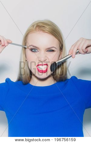 Woman Winking And Angry With Makeup Brush
