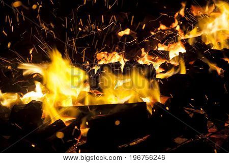 Hot sparking live-coals burning in a barbecue