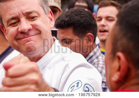 Quito, Ecuador - April 7, 2016: Closeup opposition leader Andres Paez surrounded by people and journalists during anti government protests in Shyris Avenue.