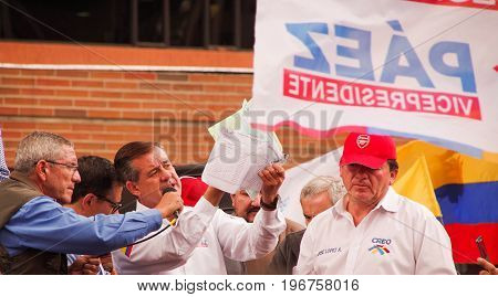 Quito, Ecuador - April 7, 2016: Closeup opposition leader Andres Paez surrounded by people and holding in his hands proofs of election fraud, police and journalists during anti government protests in Shyris Avenue.