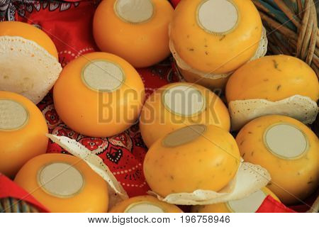 Traditional Dutch cheeses on display in a wicker basket