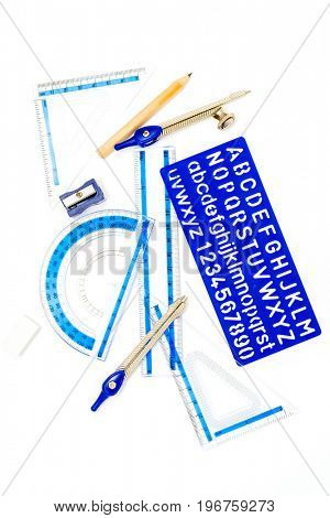 pen, ruler and setsquare on white background