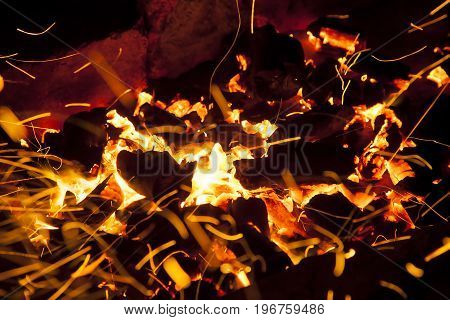 Hot sparking live-coals burning in a barbecue
