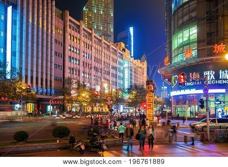 Shanghai, China - Nov 4, 2016: On intersection of Fengyang Road and Xizang Road (Middle) - in evening neon lights. Street photography.