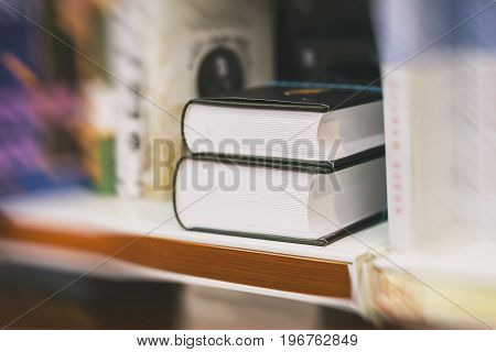 Blurred abstract background of Two thick volumes Fiction in book store or in library. Concept of education, school, study, self-study