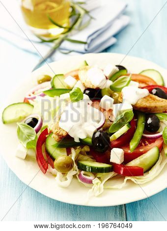 Chicken salad with tzatziki and basil leaves