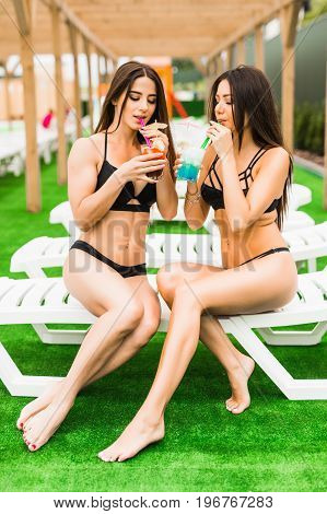 Back View Beautiful Sexy Women In Bikini Drinking A Cocktails While Relaxing In The Swimming Pool. S