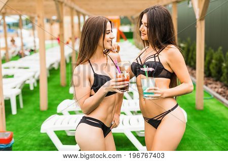 Back View Beautiful Sexy Women In Bikini Drinking A Cocktails While Relaxing In The Swimming Pool. S