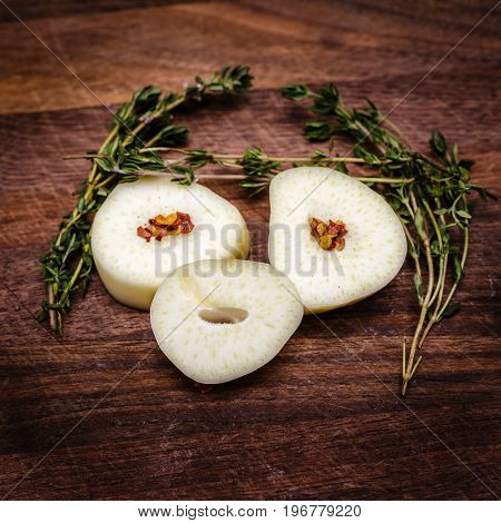 Playing around with my food. Large gloves of garlic sliced and arranged to look like a face. With fresh thyme herbs arranged to appear like hair and eye brows.