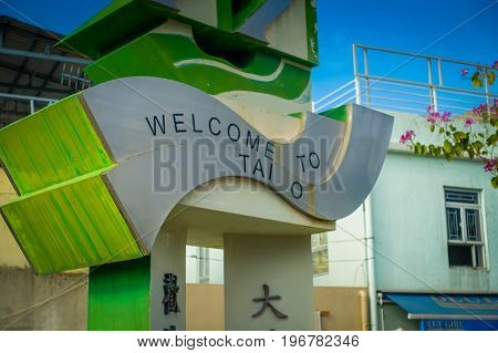 HONG KONG, CHINA - JANUARY 26, 2017: Stoned structure with an welcome sign in the enter of the fishermen town in lantau, Hong Kong, China.