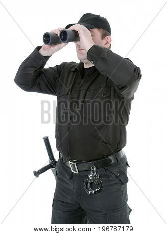 Border guard wearing black uniform looking through binocular, shot on white