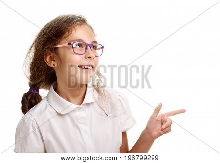 Young smiling genious schoolgirl in glasses pointing