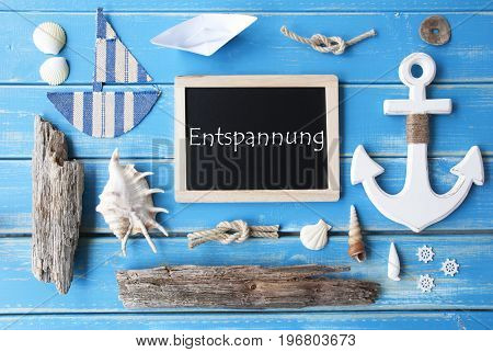 Flat Lay Of Chalkboard On Blue Wooden Background. Nautic Or Maritime Summer Decoration As Holiday Greeting Card. German Text Entspannung Means Relaxation
