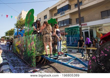 LIMASSOL, CYPRUS - FEBRUARY 26: Carnivalists in a silver cylinder hats joyfully follow the Limassol Municipality Band during the annual Carnival Parade, February 26, 2017 in Limassol.