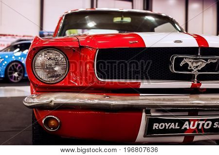 SAINT-PETERSBURG, RUSSIA - JULE 23, 2017: Front view of Classic Ford Mustang GT 390 on Royal Auto Show. Close up of Car hood and radiator with headlamp