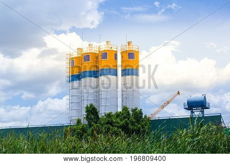 Cement concrete mixing production factory with morning light and blue sky backgroundBusiness of cement factory