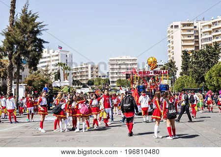 LIMASSOL, CYPRUS - FEBRUARY 26: Carnivalists in a silver cylinder hats joyfully follow the Limassol Municipality Band during the annual Carnival Parade, February 26, 2017 in Limassol.