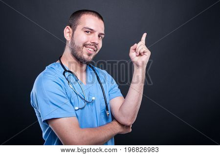 Portrait Of Doctor Wearing Scrubs With Stethoscope Having Idea