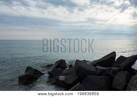 Black Rocks In The Sea At Hiddensee Island Beach Before Sunset