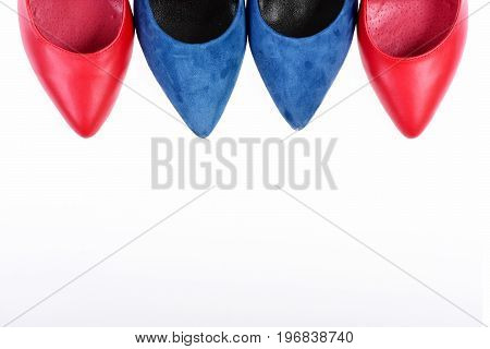 Blue and red female shoes showing toecaps only. Formal footwear with copy space. Shoe toes isolated on white background. Accessories for women. Fashion and beauty concept.