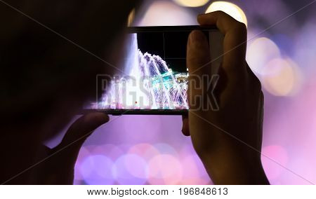 People holding their smart phone shooting video or photo.