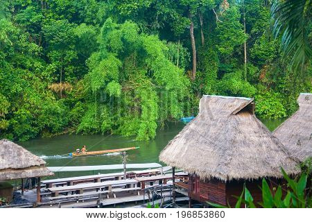 The River Kwai. Thailand. May 18 2013: A man is swimming on the river on a motor boat.