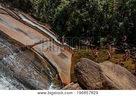 Visconde de Mauá, Brazil - January 19, 2015. View of waterfall and people in a forest at Visconde de Mauá, a village in the mountains perfect for hiking. Rio de Janeiro State, southwestern Brazil