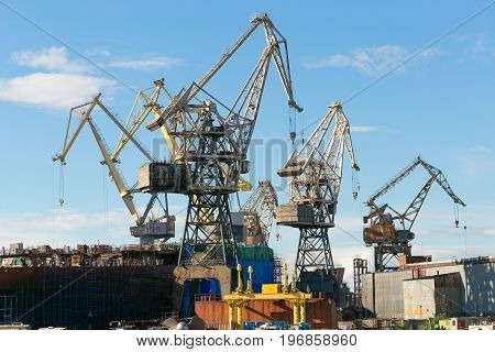 St. Petersburg Russia - 28 June 2017: port cranes operate on the Neva River in St. Petersburg