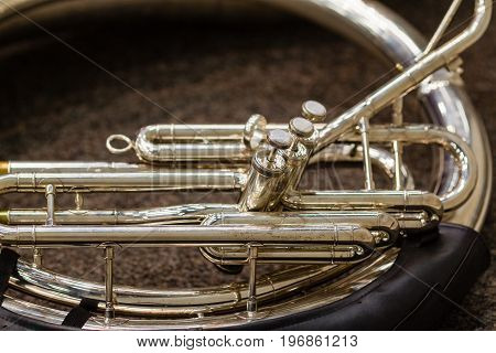 a sousaphone resting on the floor waiting for its turn to perform