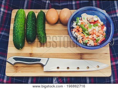 Cucumber eggs lettuce in a plate on a cutting board
