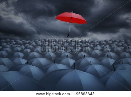 Being different concept with red umbrella outstanding from the others