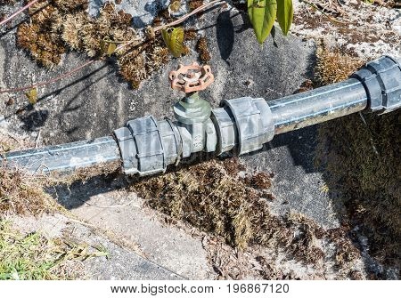 Red handle valve of the HDPE plumbing pipe for use in the garden system.