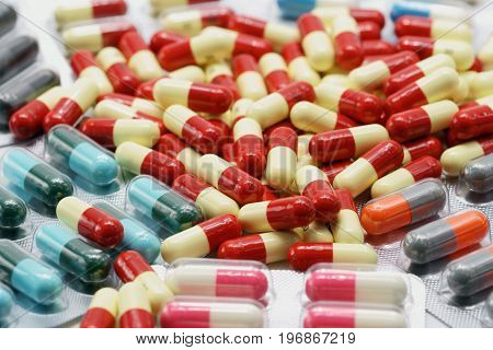 Pink, white, red, yellow, grey, orange antibiotic capsule pills