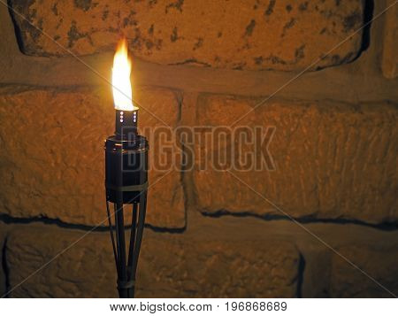 Bamboo Porch Torch On The Sandstone Wall Background In The Night