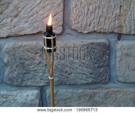 Bamboo Porch Torch On The Sandstone Wall Background