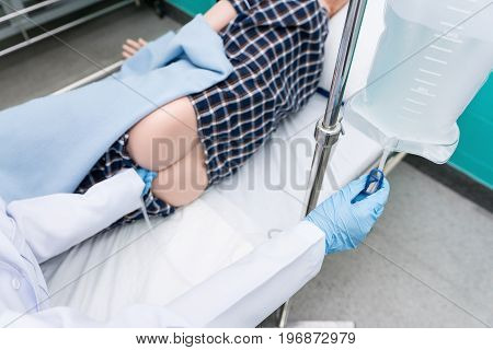 Doctor gives her patient for enema to resolve constipation problem.