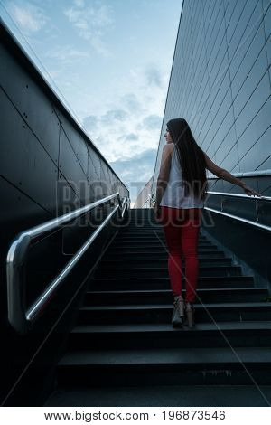young fitness woman running on mountain stairs.