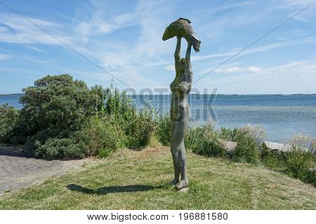 HIDDENSEE GERMANY - JUNE 20 2017: Wooden Statue At The Harbour of Hiddensee Island