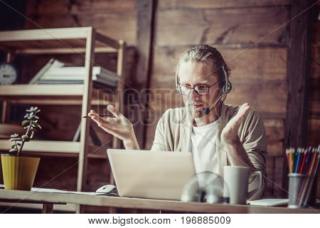 Man working on freelance negotiating online. Online conference with busnessman at home office.