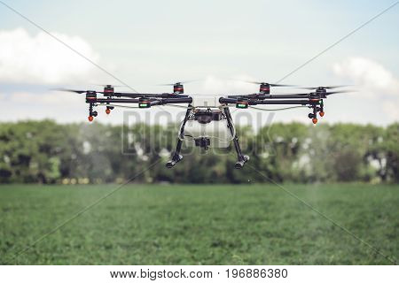 Drones spraying pesticides to grow potatoes. Industrial agriculture and smart farming concept.