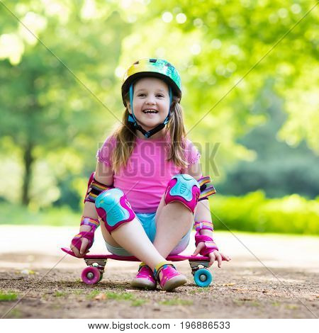 Child Riding Skateboard In Summer Park