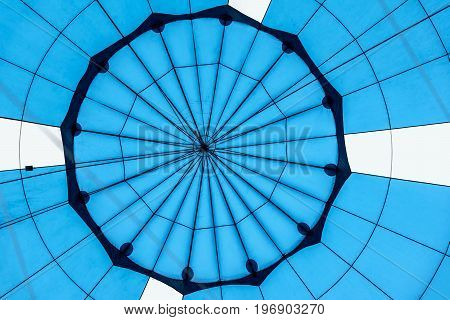 Abstract beautiful texture of a geometric surface of hot air balloon close-up. Bright blue colors. Background for bright moments of life