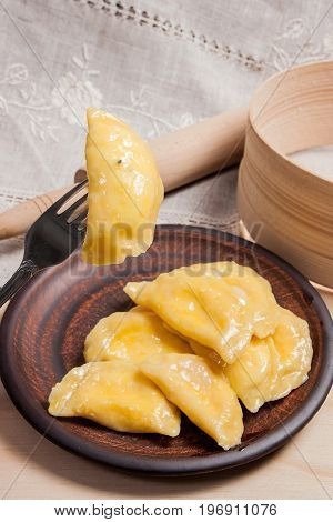 Close Up View Of Boiled Varenyky Or Dumpling With Cottage Cheese Or Curd On Metal Fork. Fresh Boiled